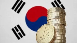 Monedas de criptomonedas junto a una bandera de Corea del Sur que representan el posible aplazamiento de los impuestos cripto hasta 2029.